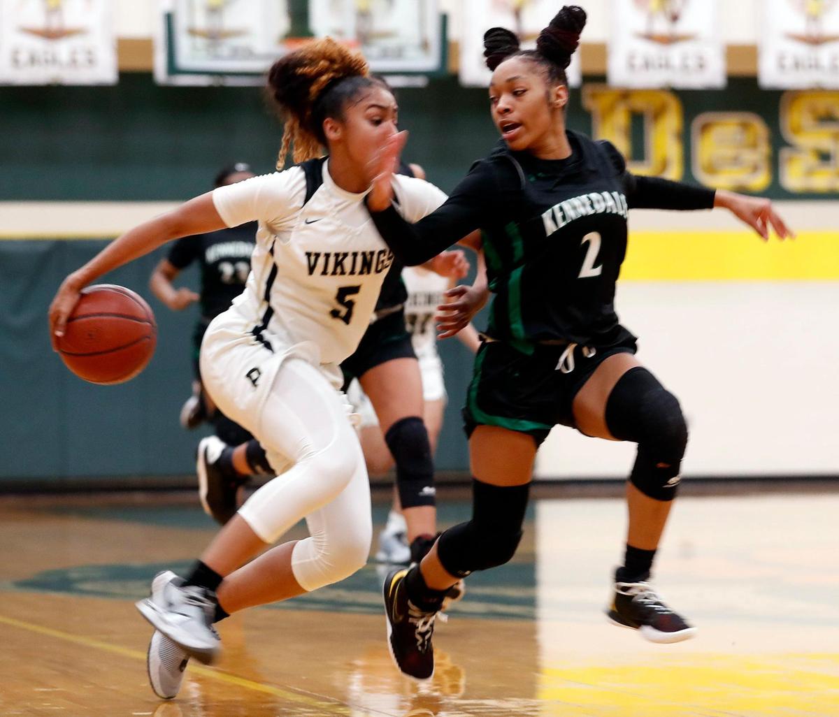 Pinkston guard Victoria Flores (5) drives down court defended by Kennedale guard Peytohn Landry (2) during the first half of a 4A Region 2 quarterfinal basketball game at DeSoto High School in DeSoto, Texas, Wednesday, Feb. 24, 2021. Pinkston led Kennedale 19-11 at the half. (Special to the Star-Telegram Bob Booth)
