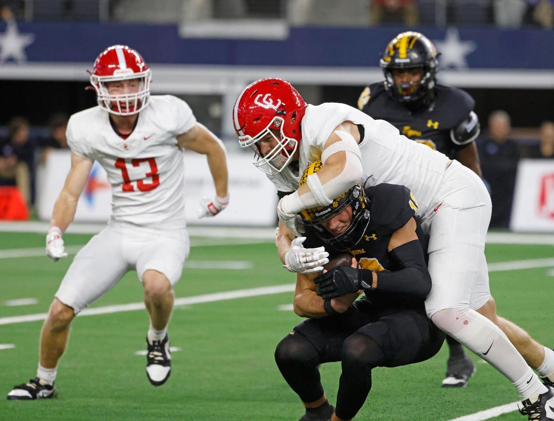 Columbus defensive lineman John Schobel (4) sacks Malakoff quarterback Mike Jones (12) for a loss during the UIL 3A D1 State Championship football game at AT&T Stadium in Arlington, Texas, Thursday, Dec. 19, 2024.