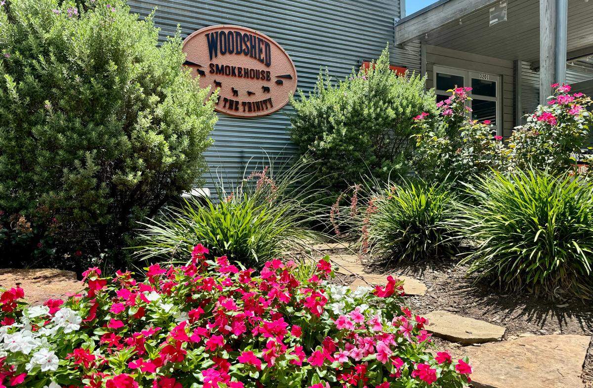 The Woodshed Smokehouse’s landscaping has grown since the restaurant opened on the levee along the Clear Fork of the Trinity River, as seen June 22, 2024.