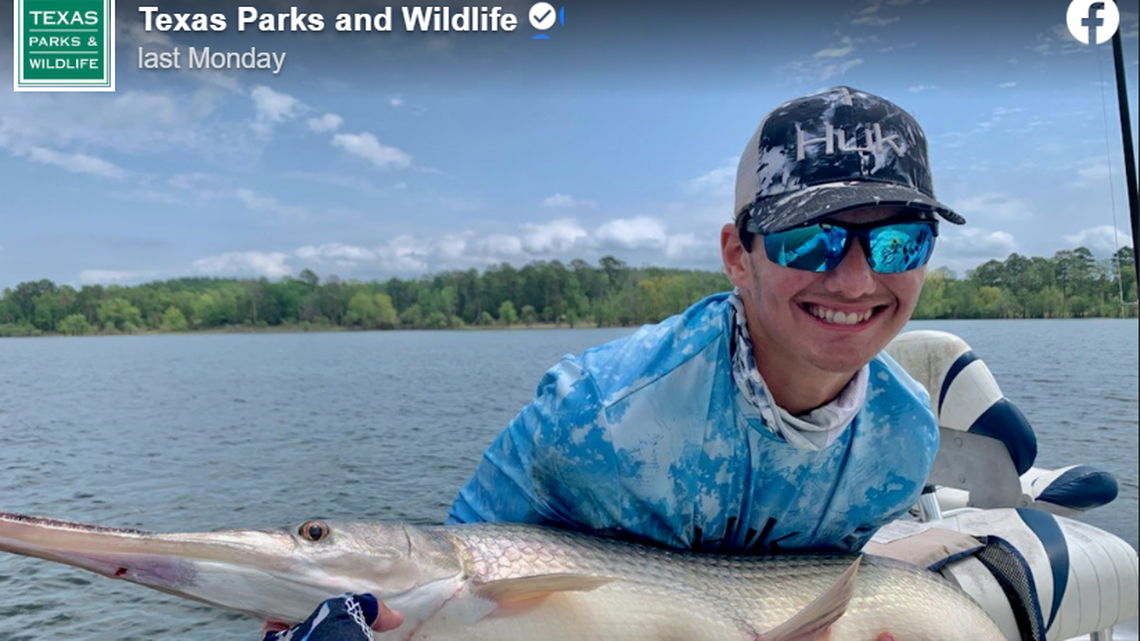 Callan Frazier, 16, with his longnose gar before releasing the fish back into Lake Sam Rayburn.