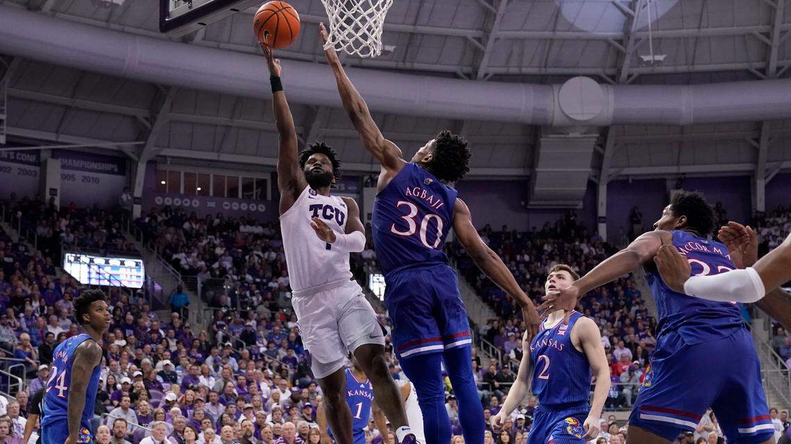 Mike Miles (1) goes up for a shot over No. 6 Kansas’ Ochai Agbaji (30) in TCU’s 74-64 win in Fort Worth Tuesday night. Coming on the heels of Saturday’s defeat of then-No. 9 Texas Tech, it marked the first time in program history that the Horned Frogs have beaten ranked teams in consecutive games.