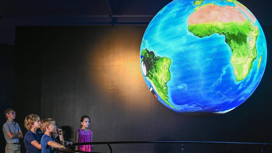 In this file photo, visitors check out an interactive globe in June 2021 at the Fort Worth Museum of Science and History on Friday. The museum returns to regular hours Tuesday, May 31.