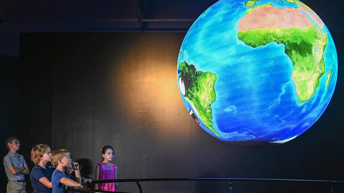 In this file photo, visitors check out an interactive globe in June 2021 at the Fort Worth Museum of Science and History on Friday. The museum returns to regular hours Tuesday, May 31.