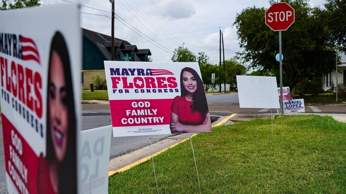 Signs for Republican congressional candidate Mayra Flores decorate the lawn outside a polling location Tuesday, June 14, 2022, for the Special Election for Congressional District 34 in Harlingen, Texas. (Denise Cathey/The Brownsville Herald via AP)