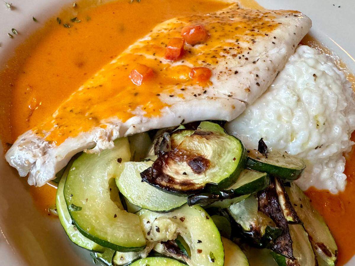 Snapper with a red pepper-coconut cream sauce, parmesan risotto and veggies at Cat City Grill.