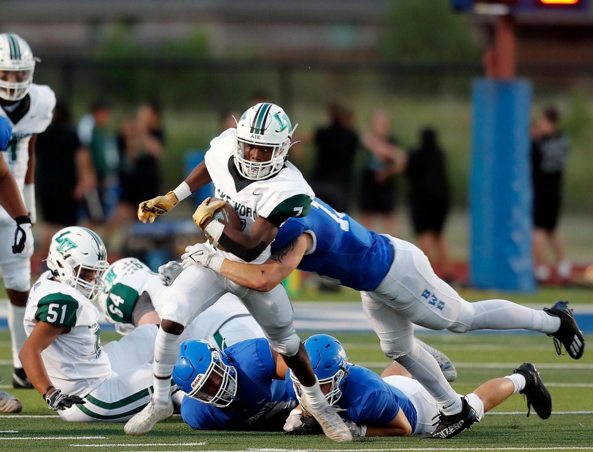 Lake Worth running back Damien Moore (7) is brought down after a gain up the middle during a high school football game at Owl Stadium in Joshua, Texas, Friday, Sept. 10, 2021. Lake Worth led Joshua by one at the half. (Special to the Star-Telegram Bob Booth)
