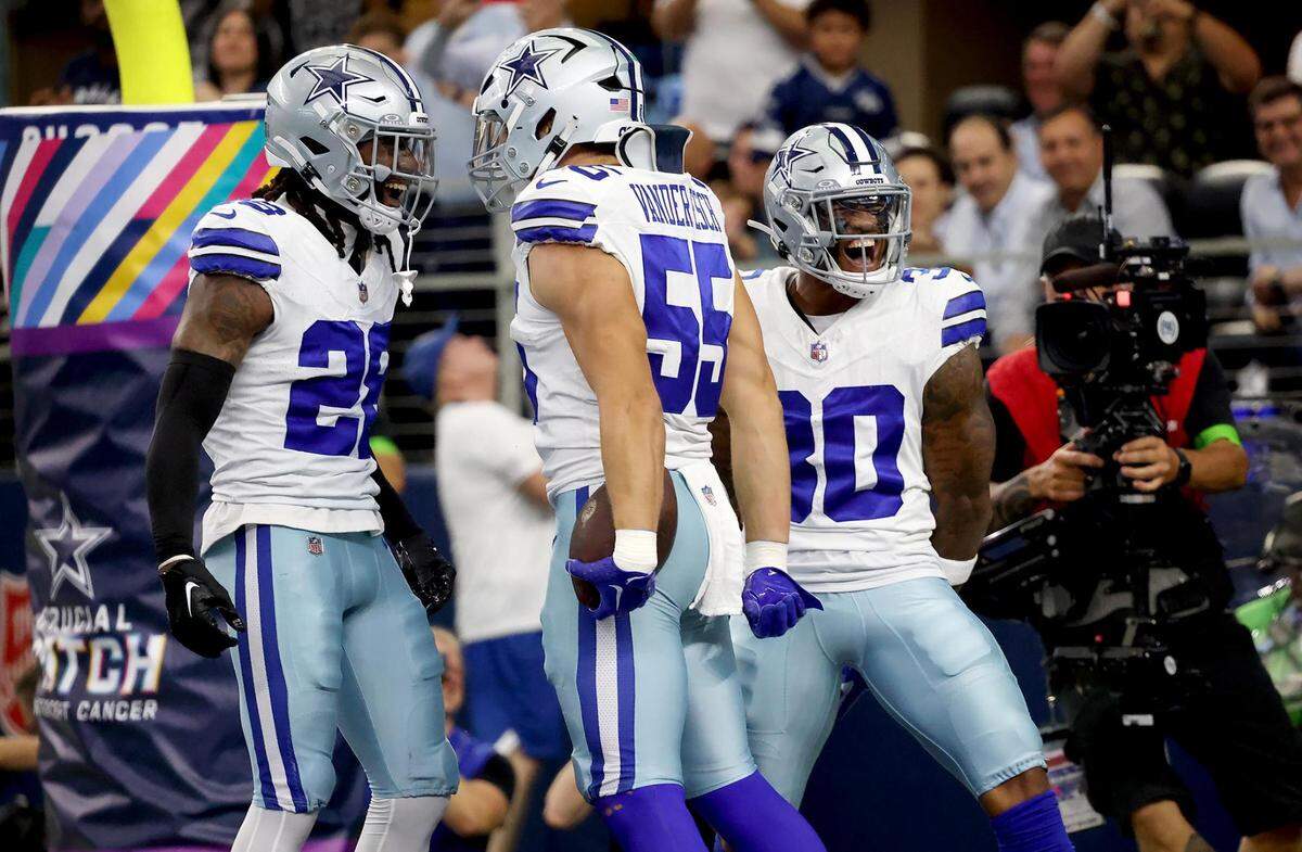 Dallas Cowboys linebacker Leighton Sander Esch, center, celebrates with teammates Malik Hooker, left, and Juanyeh Thomas after scoring a defensive touchdown against the New England Patriots on Sunday, October 1, 2023, at AT&T Stadium in Arlington.