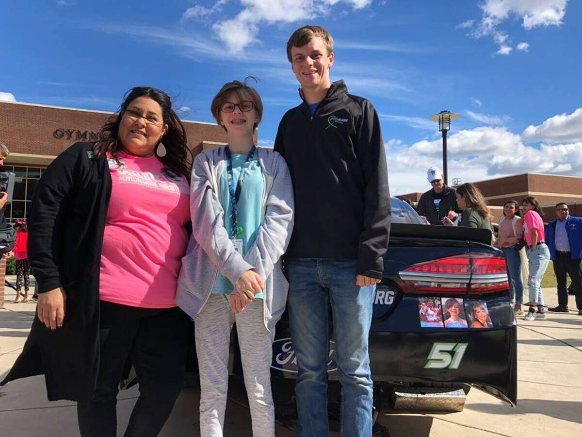 Emily Avila (left), Casey Huff and Joey Gase. Photos of Casey and Emily’s daughter Cassie are on the bumper right corner of Gase’s No. 51 car.
