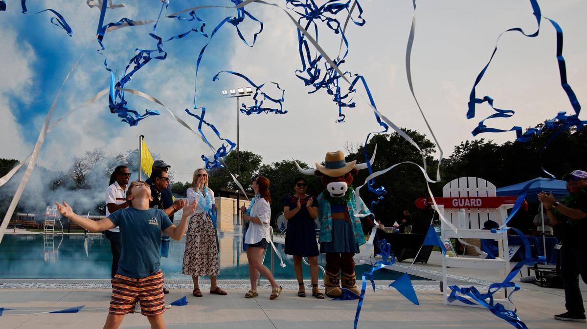 Fort Worth Mayor Mattie Parker’s son Laney, 8, watches the ribbons after he and his mother cut the ribbon for the grand re-opening of Forest Park Pool in Fort Worth, Texas, Friday May 24, 2024. (Special to the Star-Telegram/Bob Booth)