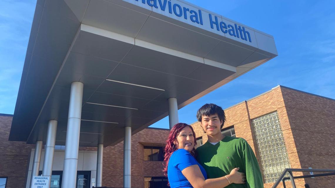 Cecilia Mora with her son, Joel Salas, outside of the entrance to Texas Health Behavioral Health Center Arlington. Mora, a nurse and supervisor at the hospital, didn’t know Joel was struggling with depression until he called 911 in a crisis.
