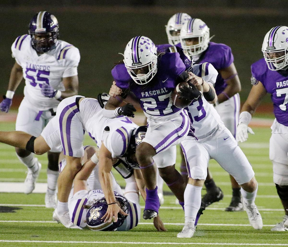Pashal’s Maki Gee breaks tackles during a UIL football game at Farrington Field Stadium on Thursday, October 4, 2024.