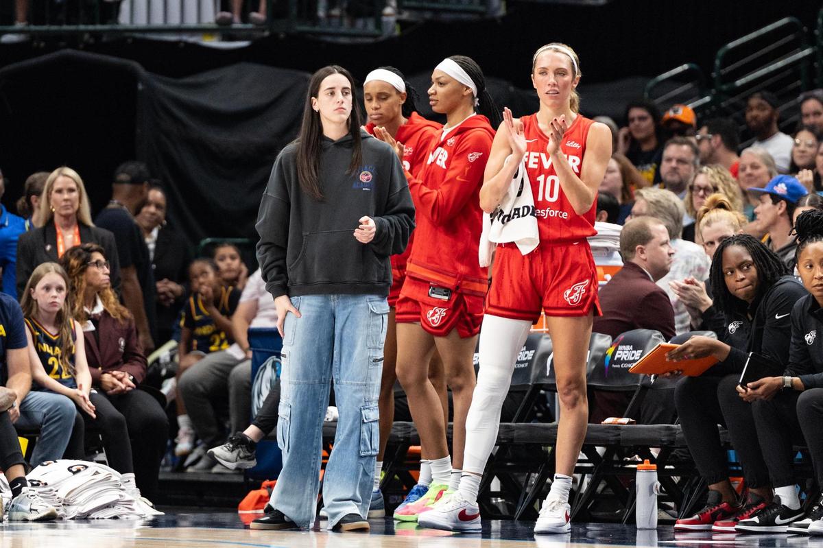 Indiana Fever guard Caitlin Clark remains sidelined due to injury during the first half of a WNBA game between the Dallas Wings and Indiana Fever at the American Airlines Center in Dallas on Friday, June 27, 2025.