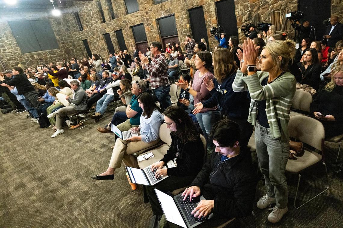Meeting attendees stand and cheer following board member Chelsea Kelly’s remarks during a special meeting regarding the possible split of the Keller Independent School District at the Keller ISD Education Center in Keller on Thursday, Jan. 16, 2025.