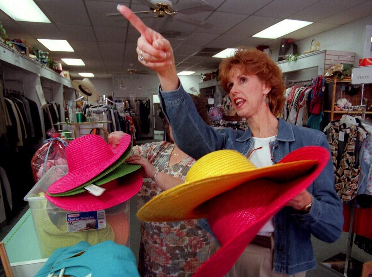 March 18, 1999: Jan Westlake, a Southlake Newcomers Club volunteer, looks for a place to hang some hats at the Second Glance resale shop where she works in Grapevine.