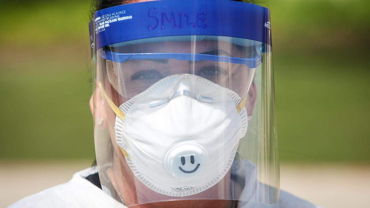 Stephanie Bedunah, a nurse for Questcare Medical Clinic at Burleson, drew a smiley face on her respirator so that patients would know she was smiling underneath all of her personal protective equipment.