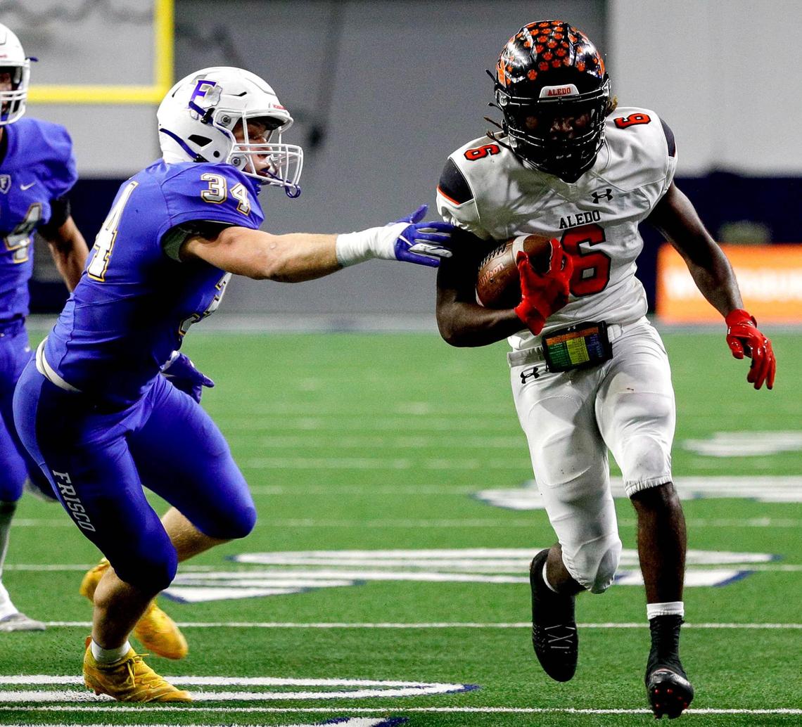 Aledo running back Demarco Roberts (6) finds a big hole to run against Frisco linebacker A.J. Yasilli (34) during the first half of the 5A Division II Regional round high school football playoffs, December 24, 2020, played at The Ford Center at the Star in Frisco, Tx. (Steve Nurenberg Special to the Star-Telegram)