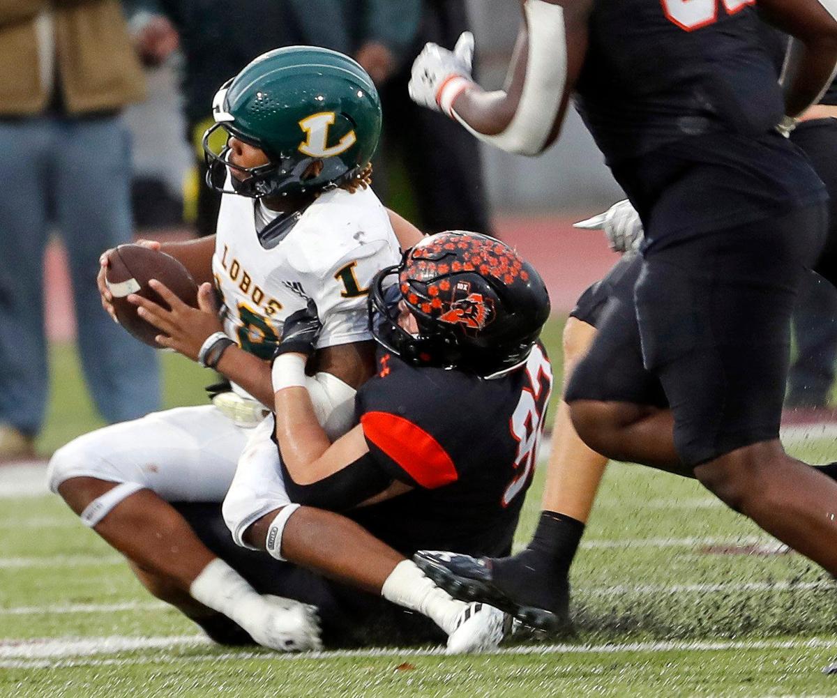 Aledo defensive tackle Bryon Wheeler (92) drops Longview quarterback Jordan Allen (12) in the backfield in the second half of a UIL Class 5A D1 state semifinal football game at the John Kincaide Stadium in Dallas, Texas, Saturday, Dec. 10, 2022. Under several weather delays Aledo led Longview 17-14 with :56 seconds remaining in the game. (Special to the Star-Telegram Bob Booth)