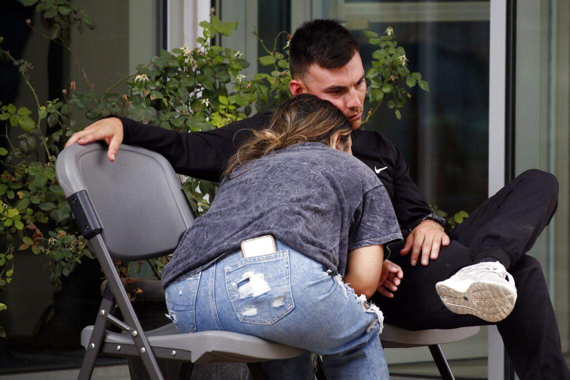 People wait outside of the Civic Center in Uvalde, Texas, Tuesday, May 24, 2022. An 18-year-old gunman opened fire at Robb Elementary School, killing multiple people. Gov. Greg Abbott says the gunman entered the school in Uvalde with a handgun and possibly a rifle. (AP Photo/Dario Lopez-Mills)