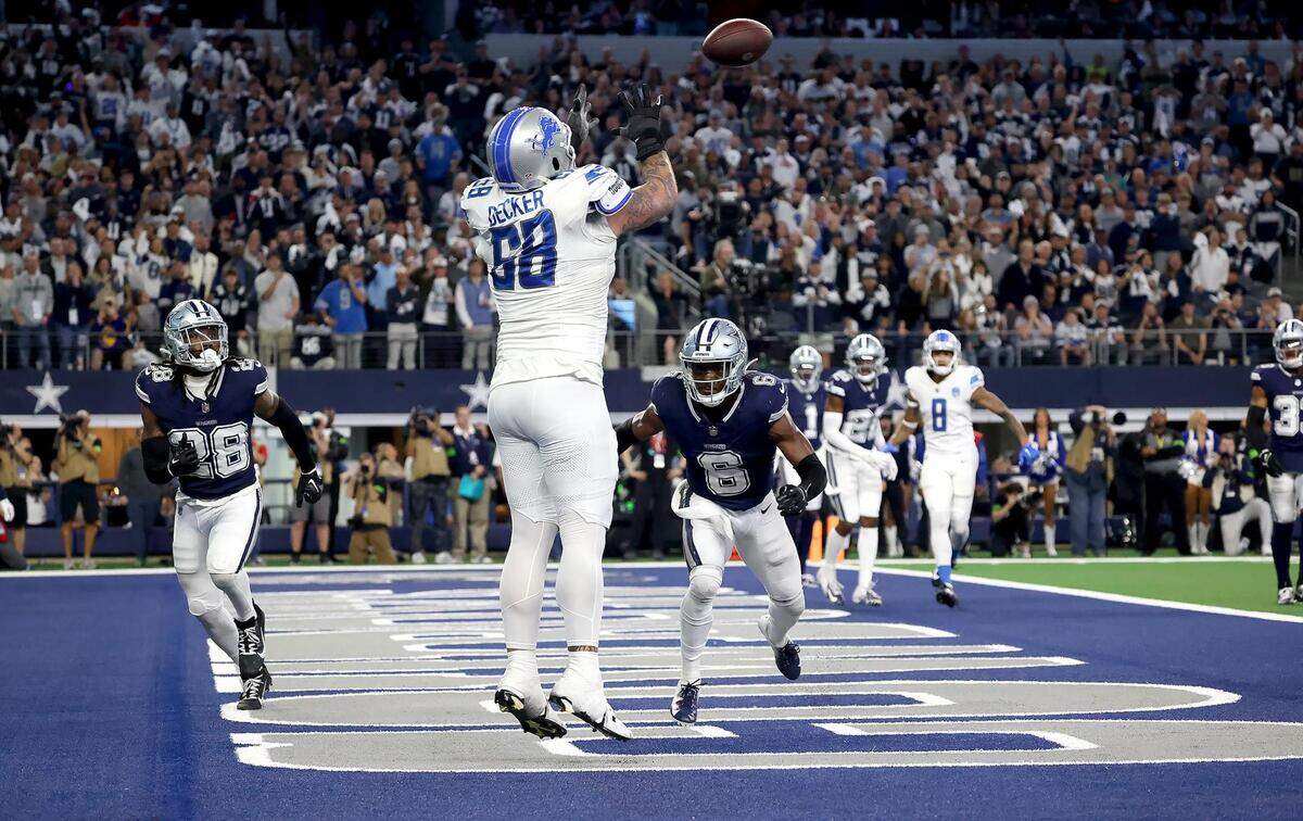 Detroit Lions offensive lineman Taylor Decker catches the ball in the end zone during a two-point conversion play in the final seconds of the NFL regular season game against the Dallas Cowboys on Saturday, December 30, 2023. The referees called an illegal touching penalty on the play in a controversial call that led to the Cowboys winning, 20-19.