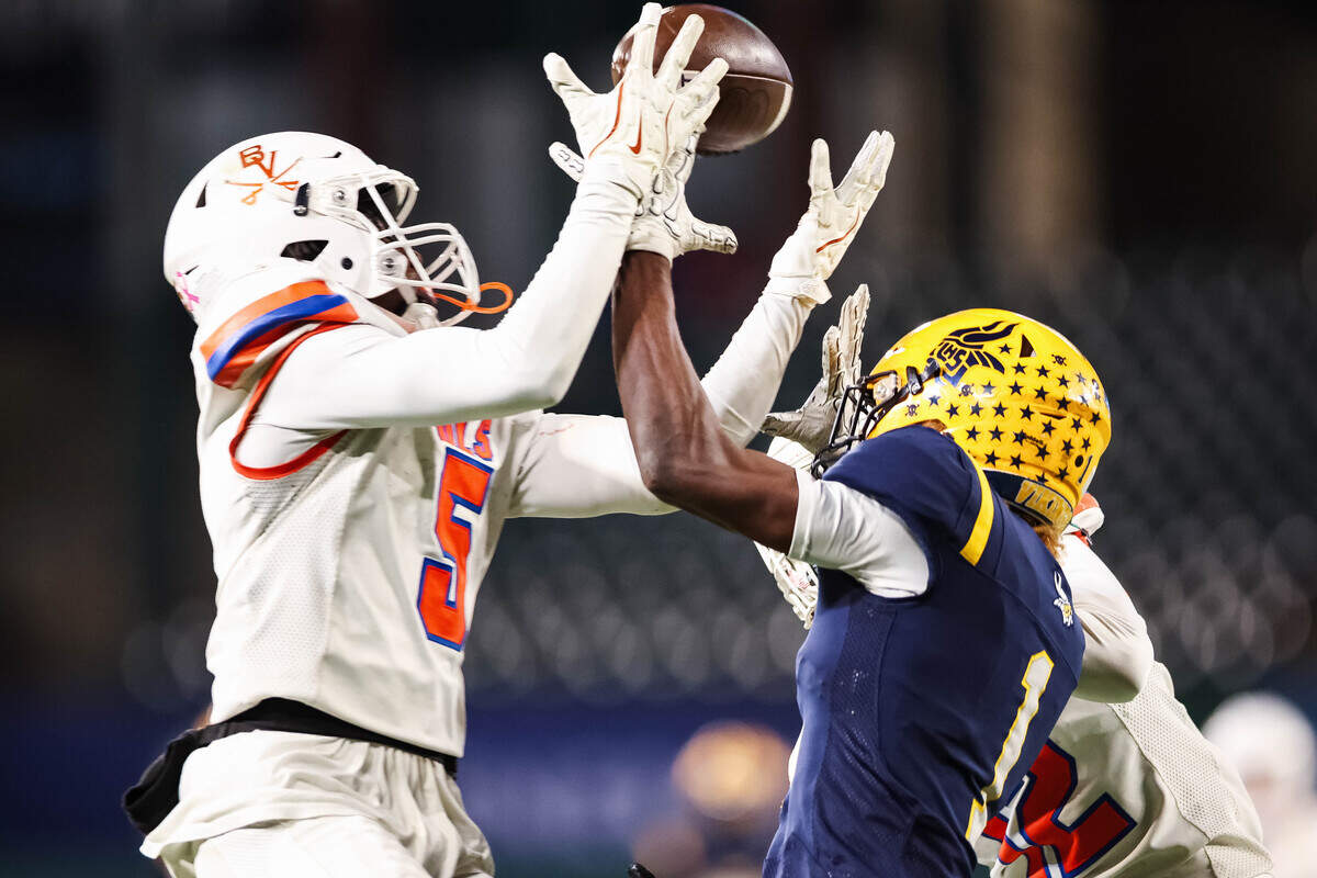 Arlington Bowie defensive back Princeton Campbell (5) goes up to deflect a pass against Arlington Lamar wide receiver Khamill Pruitt (1) in a district matchup at Choctaw Stadium in Arlington, Texas on October 30, 2025.