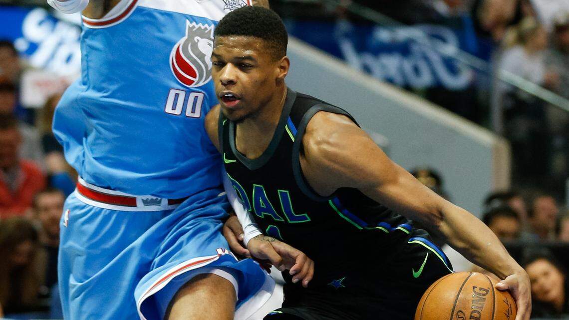 Dallas Mavericks guard Dennis Smith Jr. (1) drives on Sacramento Kings center Willie Cauley-Stein (00) during a game at American Airlines Center in Dallas, TX.
