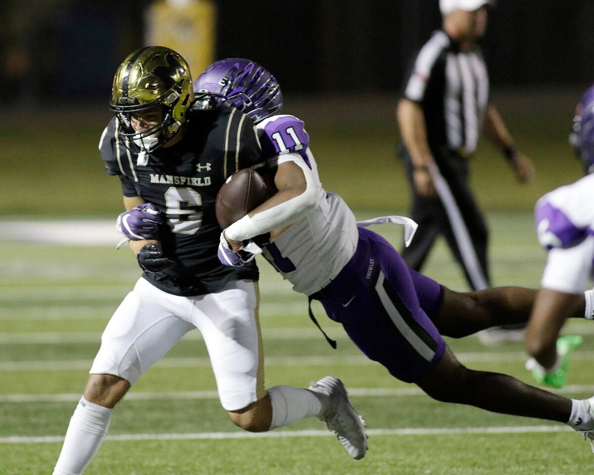 Mansfield’s Jonah Hand manages to hang on to the ball as he is tackled during a UIL football game at Newsome Stadium on Saturday , October 10, 2024.