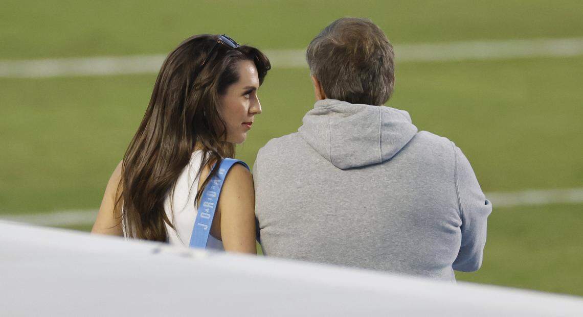 Jordon Hudson talks to North Carolina head coach Bill Belichick as the team warms up before North Carolina’s game against TCU at Kenan Stadium in Chapel Hill, N.C., on Monday.