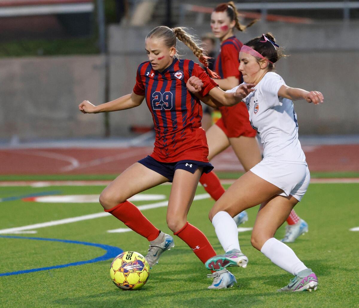 Frisco Wakeland forward Audrey Gilbert (21) battles Grapevine defender Claire Jenkins (29) just before her shot on goal during the Class 5A D2 UIL state semifinal girls soccer playoff game at Buddy Echols Field in Coppell, Texas, Friday, Apr. 05, 2025.