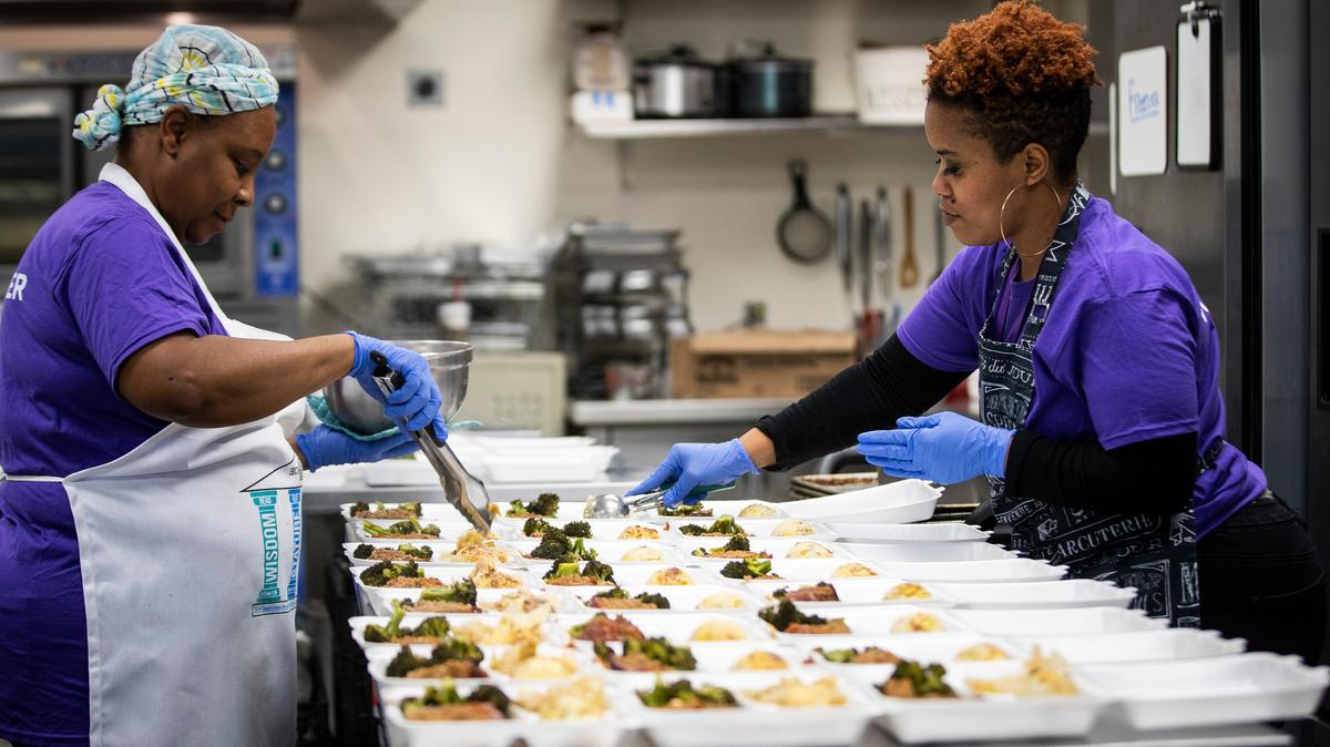 Chefs Angela Jones and Brandy Gibbons prepare hot meals to deliver for Hope Farm mothers and children amid the coronavirus outbreak Tuesday, March 31, 2020, in Fort Worth. Normally, the nonprofit feeds the boys at the facility on weekdays.