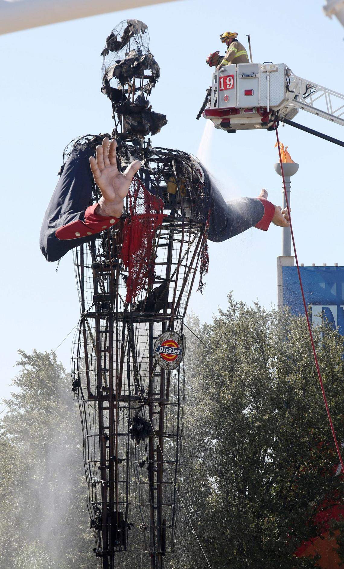 Dallas firefighters put out the last hot spots after Big Tex caught fire at the State Fair of Texas in Fair Park, on Friday, October 19, 2012
