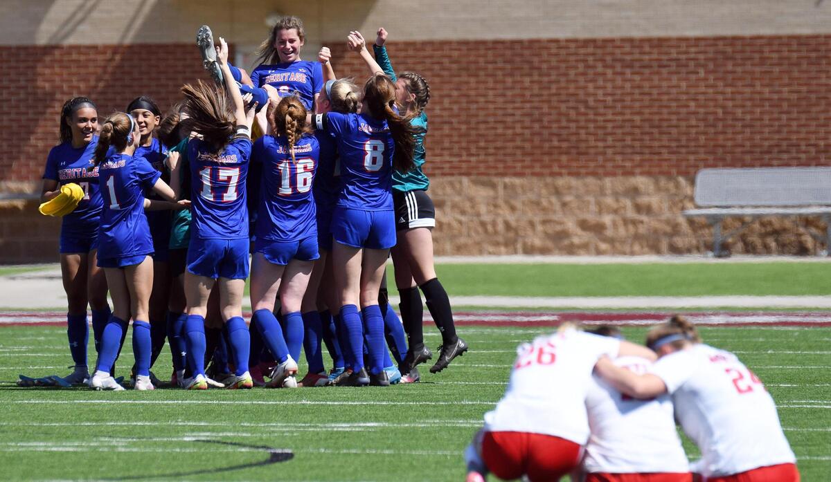 Midlothian Heritage’s Jules Burrows, left center is lifted on the shoulders of her teammates as Argyle players console each other after Midlothian beat Argyle 2-1 in the Region 1-4A girls soccer final Saturday, April 9, 2022 at Northwest ISD Stadium in Justin Texas. Special/Bob Haynes