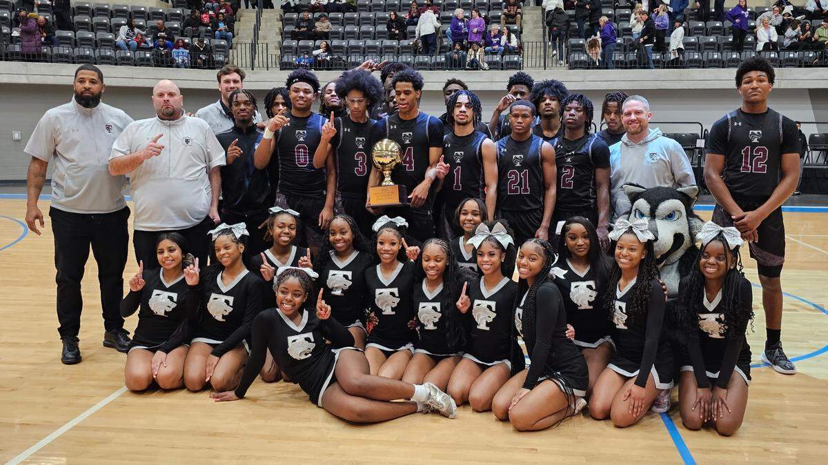 The Mansfield Timberview basketball team and cheer squad pose with the trophy after defeating Fort Worth Paschal in a Class 5A Division 1 bi-district contest on Tuesday, February 18, 2025 at the Arlington ISD Athletics Center in Arlington, Texas. Timberview downed Paschal 62-39.
