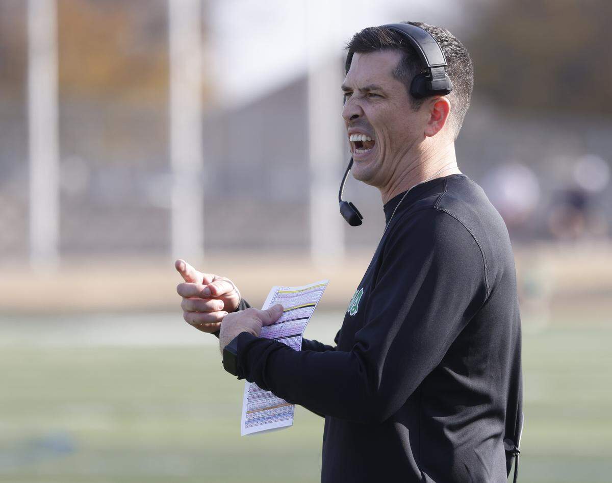 Southlake Carroll head coach Riley Dodge converses with an official during the first half of a Class 6A Division II state semifinal Saturday at Newsom Stadium in Mansfield.