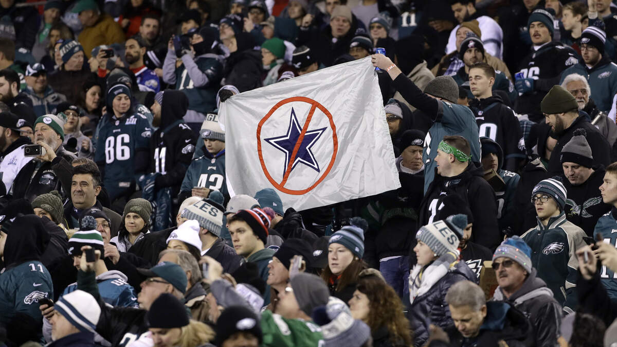 Fans hold up a sign before the Philadelphia Eagles and the Dallas Cowboys met Sunday night at Lincoln Financial Field.