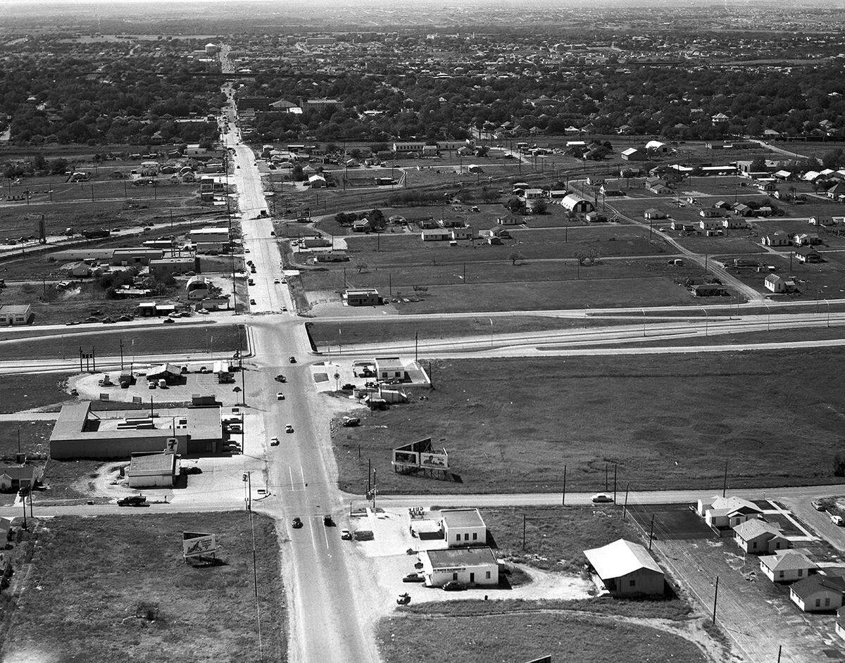 Sept. 14, 1953: East Berry Street, looking west, with the interchange of future Interstate 35W in the foreground. “A major cross-town artery was improved recently with widening of East Berry Street from 30 to 60 feet between Hemphill to North-South Freeway. The widening cost $132,500. Property owners paid $52,000 of that at rate of $11.25 per front foot. The city paid $67,000 for work at intersections. Frisco, Southern Pacific and Katy Railroads paid $13,500 for grade crossing work at their tracks. Costs included all paving, curb and gutter work.”