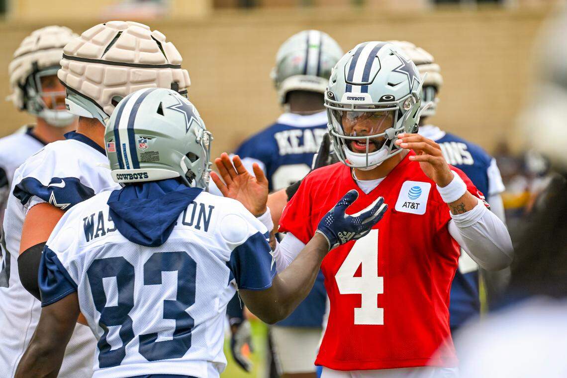 Dallas Cowboys quarterback Dak Prescott (4) celebrates a play with wide receiver James Washington (83) during training camp. Washington was injured on Monday.