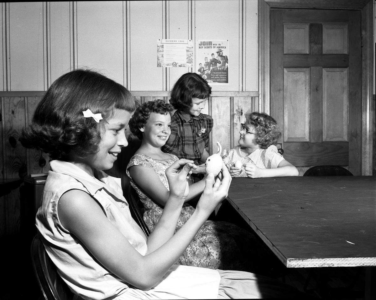 April 15, 1954: Members of Girl Scout Troop 46 prepare tray favors for Fort Worth Children’s Hospital for Easter morning. Left to right, Maria Dianne Francis, Lana Nobles, Sonja Elam and Margaret Box. Mrs. George F. Nobles, 4104 Curzon, is the troop leader.