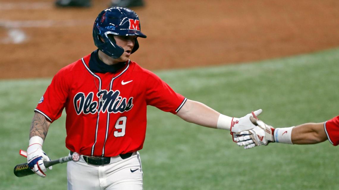 Ole Miss outfielder Hayden Leatherwood (9) is congratulated after scoring during the 2021 College Baseball Showdown at Globe Life Field in Arlington, Texas, Saturday, Feb. 20, 2021. (Special to the Star-Telegram Bob Booth)