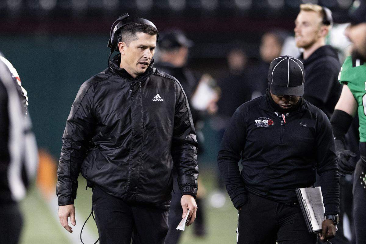 Southlake Carroll head coach Riley Dodge heads back to the sideline in the first half of the UIL Division II Regional playoff game at Choctaw Stadium in Arlington on Friday, Nov. 28, 2025.
