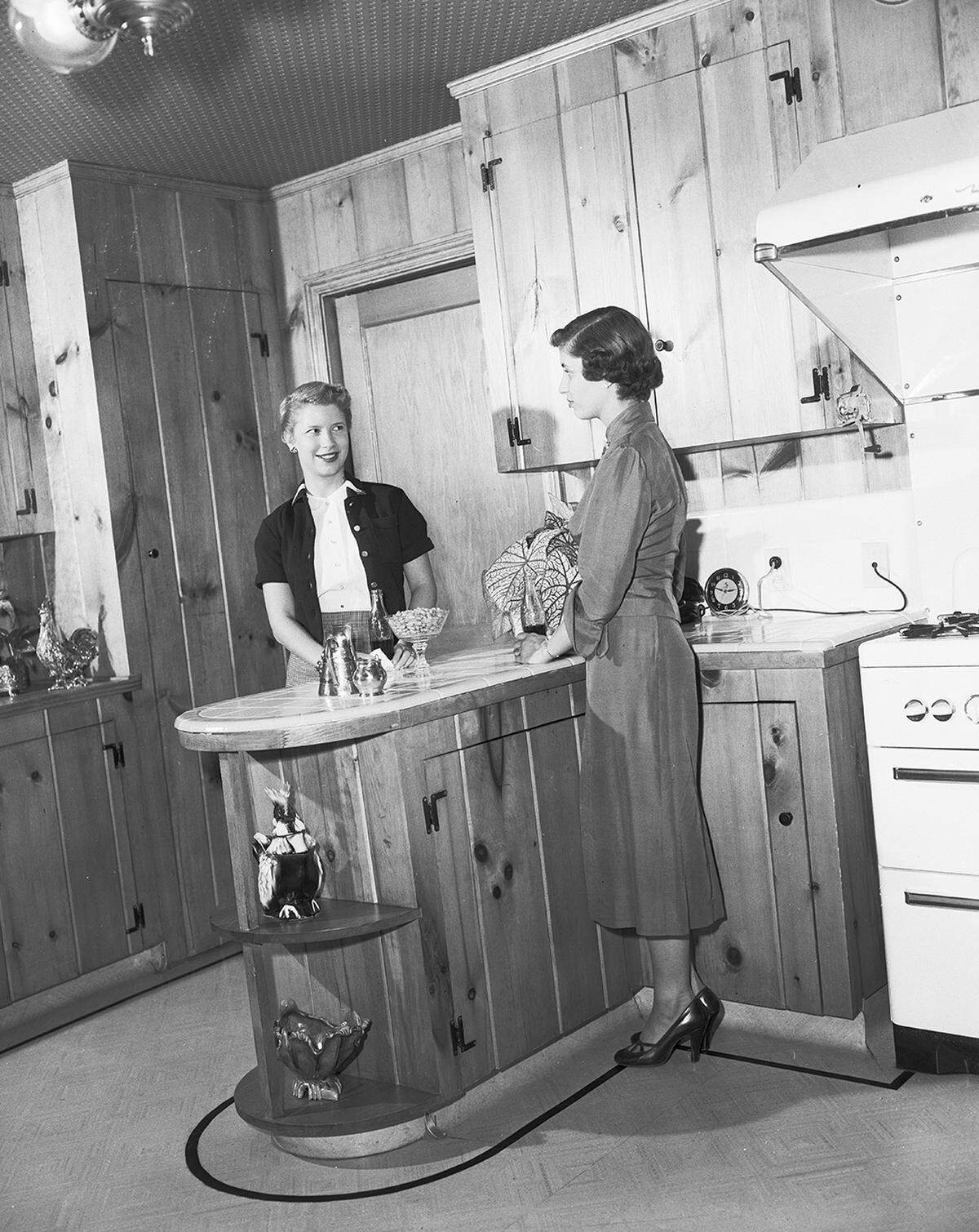 Sept. 28, 1952: Carolyn Kemble and Kay Lockman chat in the kitchen of Mrs. J.H. Grammer, 408 N. Bailey.
