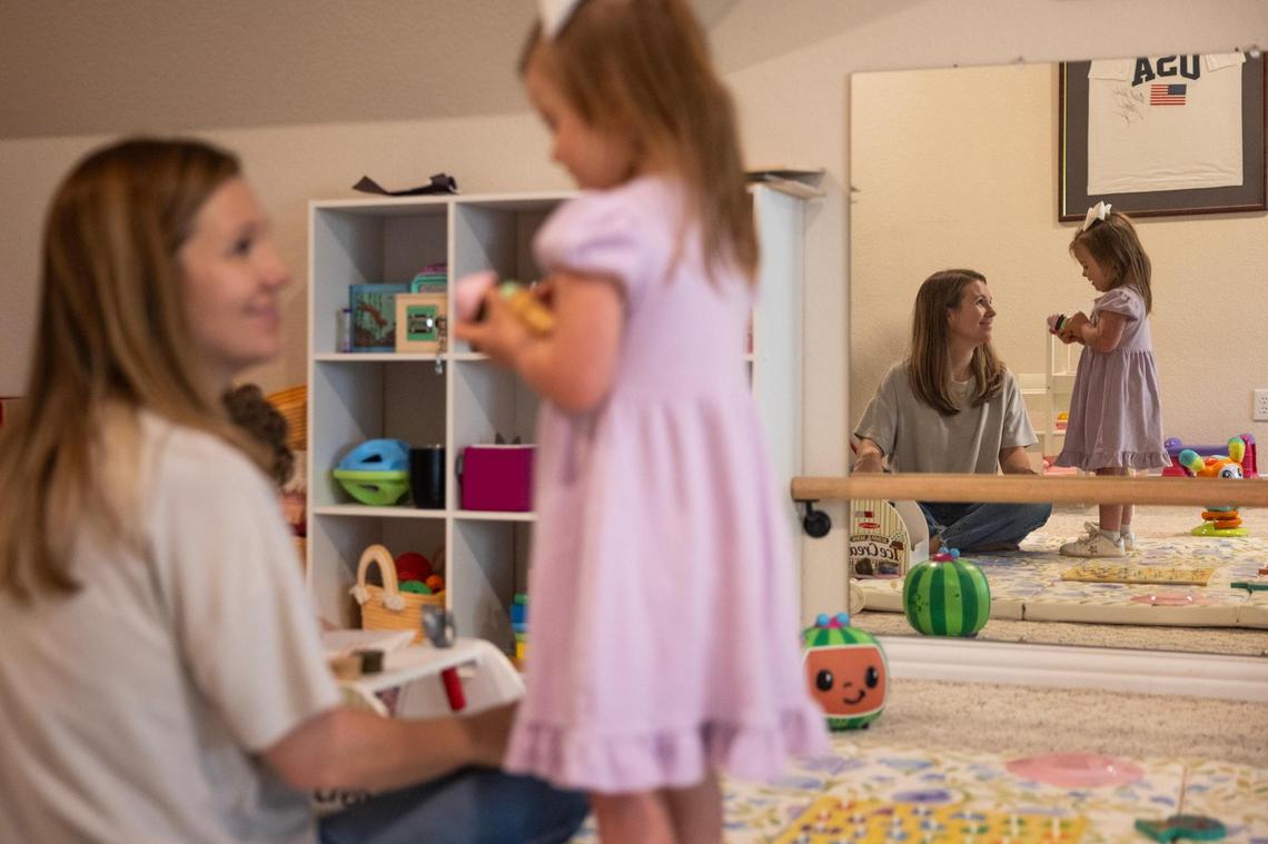 Courtney Morey, left plays with her daughter Annie, 4, in the upstairs play room of their home in North Texas on Friday, March 28.