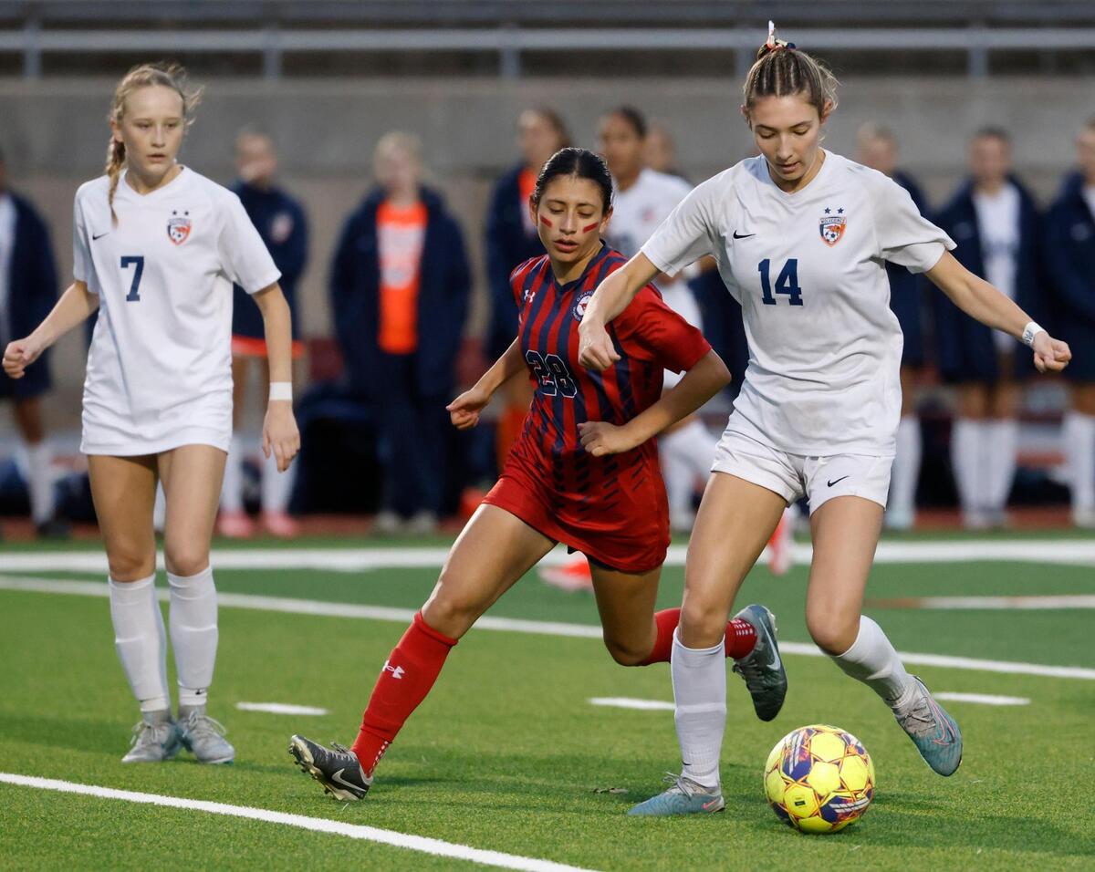 Frisco Wakeland midfielder Kendi Smith (14) works against Grapevine stricker Paola Granados (28) during the Class 5A D2 UIL state semifinal girls soccer playoff game at Buddy Echols Field in Coppell, Texas, Friday, Apr. 05, 2025.