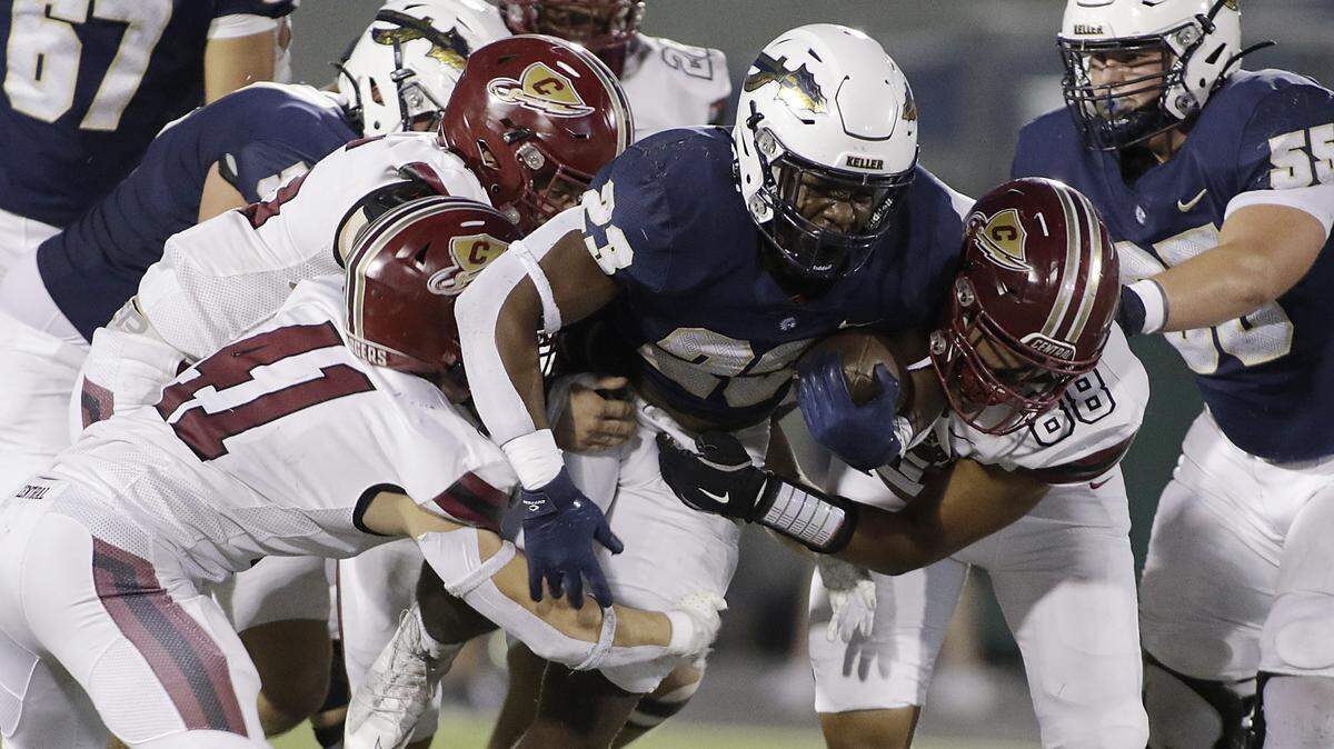 Keller’s David Makia (23) runs though a host of Keller Central tacklers during their game at Keller Athletic Complex on Friday, Sep. 26 ,2025.