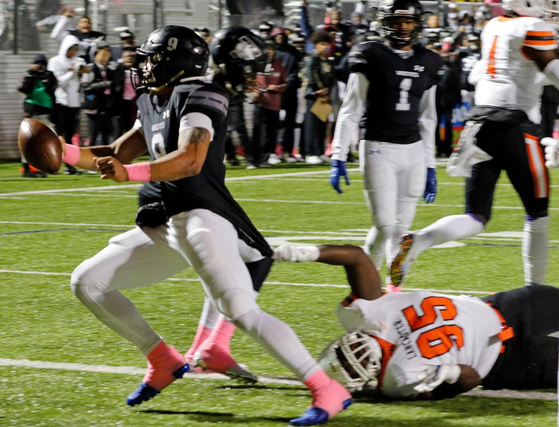 Timberview quarterback Jaden Hullaby (9) drops the ball as he drags Lancaster defensive lineman Jordan Washington (95) into the end zone for their first score during a high school football game at R. L. Anderson Stadium in Mansfield, Texas, Friday, Oct. 25, 2019. Lancaster led by 7 at the half. (Special to the Star-Telegram Bob Booth)