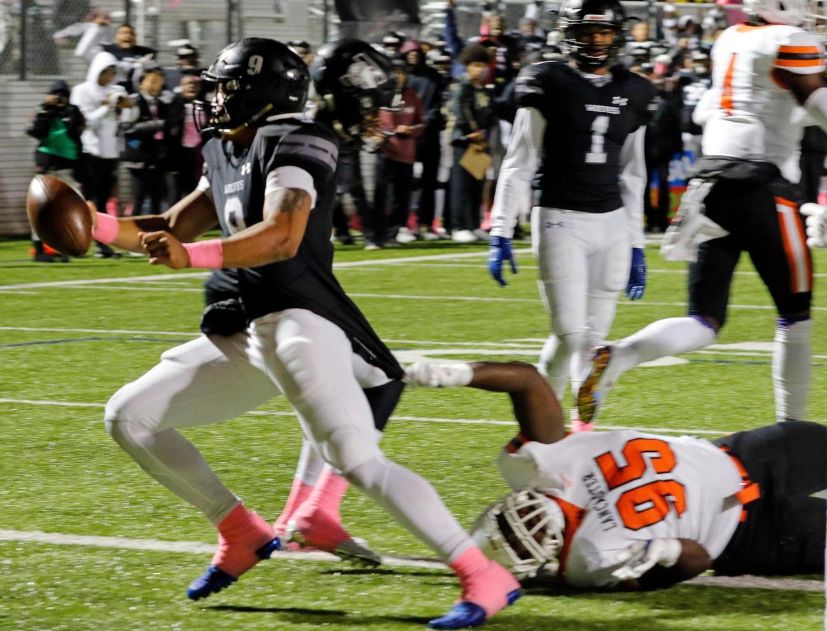 Timberview quarterback Jaden Hullaby (9) drops the ball as he drags Lancaster defensive lineman Jordan Washington (95) into the end zone for their first score during a high school football game at R. L. Anderson Stadium in Mansfield, Texas, Friday, Oct. 25, 2019. Lancaster led by 7 at the half. (Special to the Star-Telegram Bob Booth)
