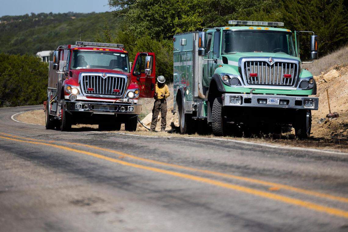 Fire crews fight a wildfire along FM 1148 on Tuesday, July 19, 2022, near Possum Kingdom Lake in Graham. The fire had consumed 500 acres and was 10 percent contained.