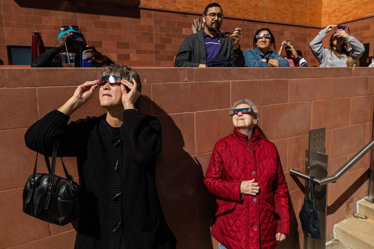 Debra Wilson, left, and Ruth Reed join other spectators in viewing the solar eclipse during the Annular Solar Eclipse event at the Fort Worth Museum of Science & History on Saturday, Oct. 14, 2023.