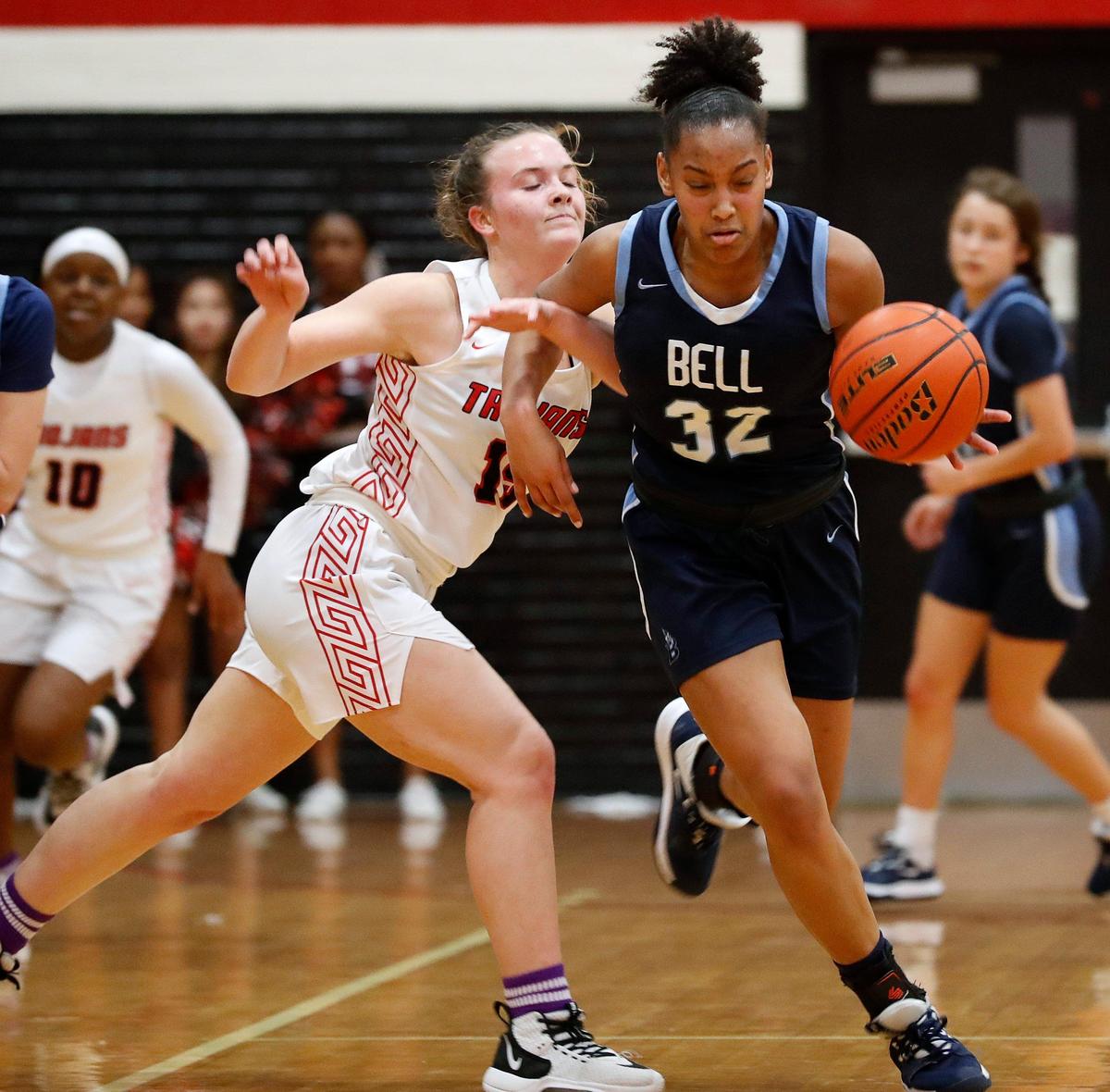 L.D. Bell’s Jayden Rhodes brings the ball down court defended by Trinity’s Caitlyn Branton in the third quarter of a high school basketball game at Trinity High School in Euless, Texas, Jan. 28, 2020. Bell led Trinity 52-19 after three frames. (Special to the Star-Telegram Bob Booth)