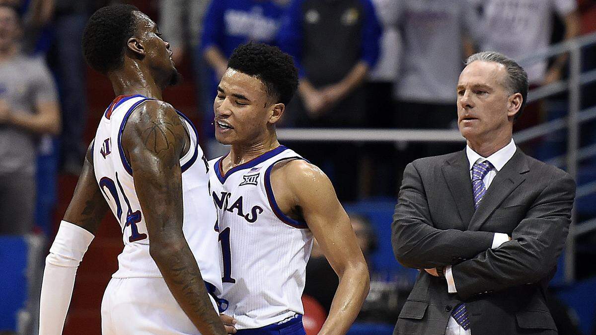 After blocking the shot of TCU’s Alex Robinson late in Wednesday night’s game, KU guard Devon Dotson got a hearty chest bump from teammate Lagerald Vick, left, as TCU coach Jamie Dixon looks on. KU beat TCU, 77-68.