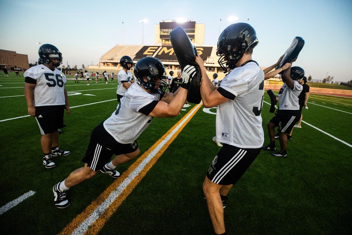 Eagle Mountain High school football players practice their shoving techniques on Monday, August 5, 2024. Players ran through defense drills in preparation for the starting football season.